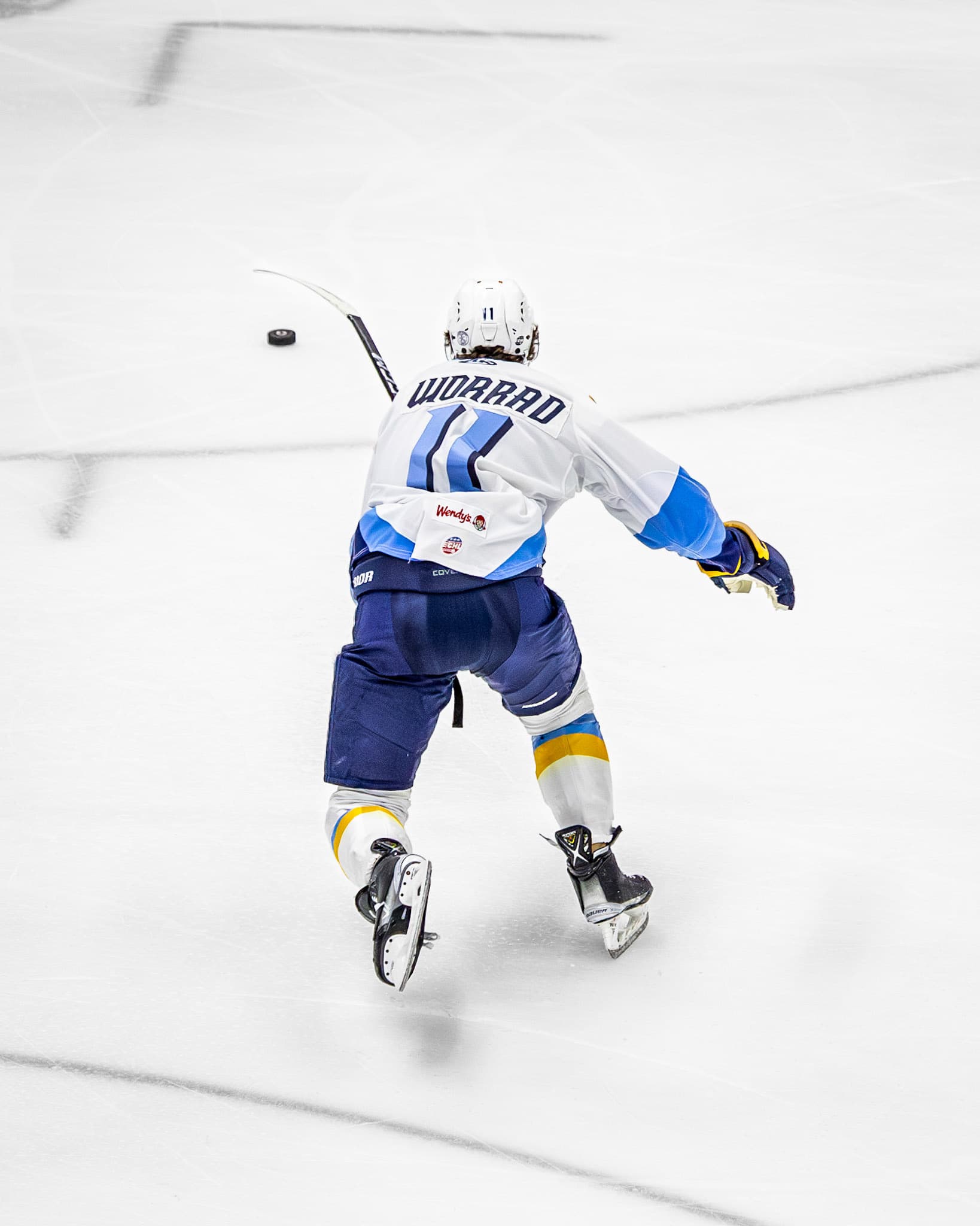 A Toledo Walleye player skates up the ice, seen from above.