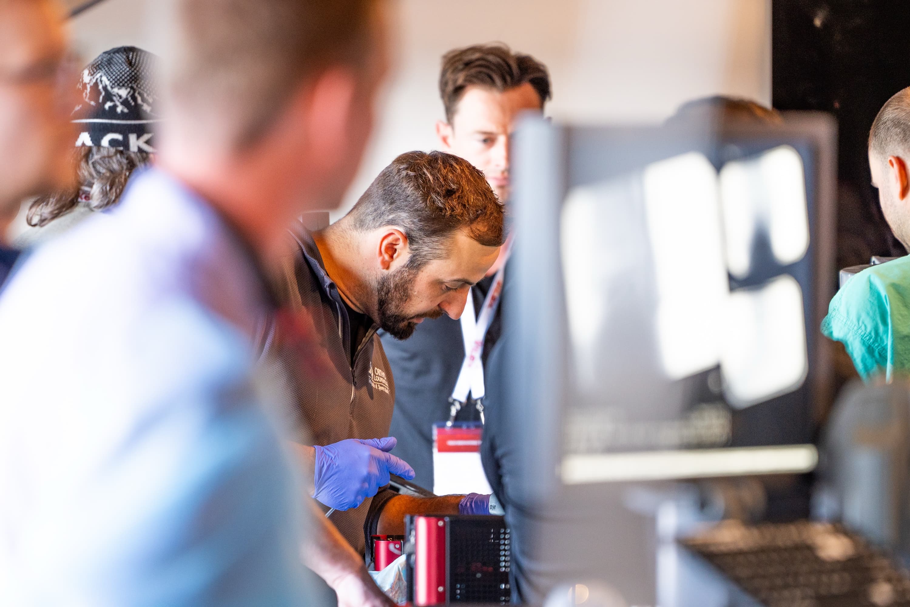 Attendees gather around a hands-on demonstration at Innovations 2024.